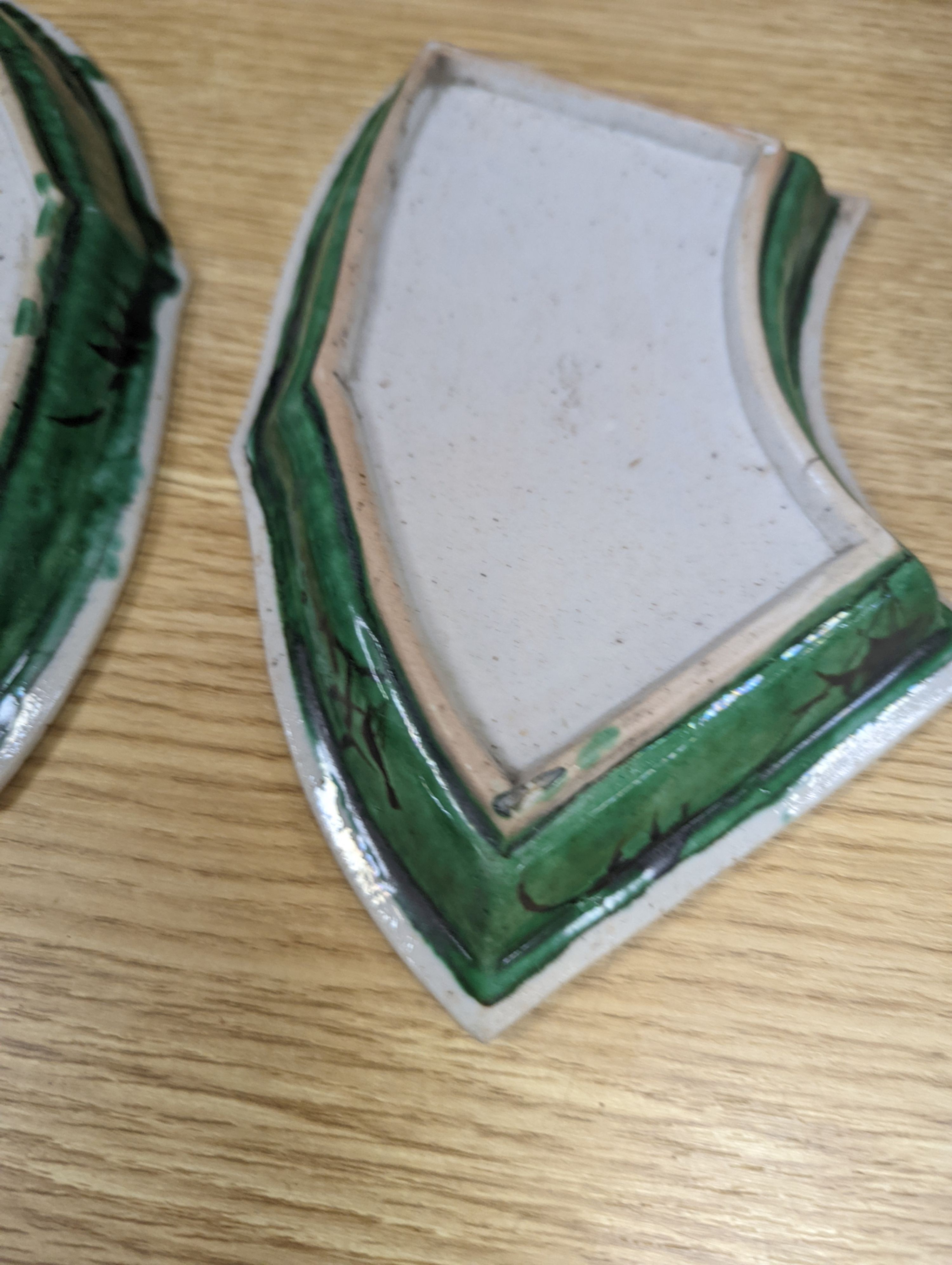 A pair of Chinese famille verte biscuit fan-shaped sweetmeat dishes, Kangxi, 20 cms wide.